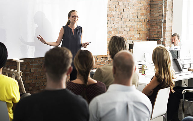 woman-speaking-to-team