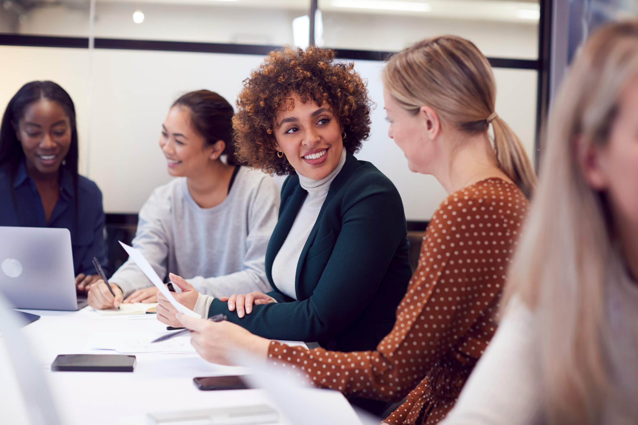 An image of people of different cultures having conversations and working