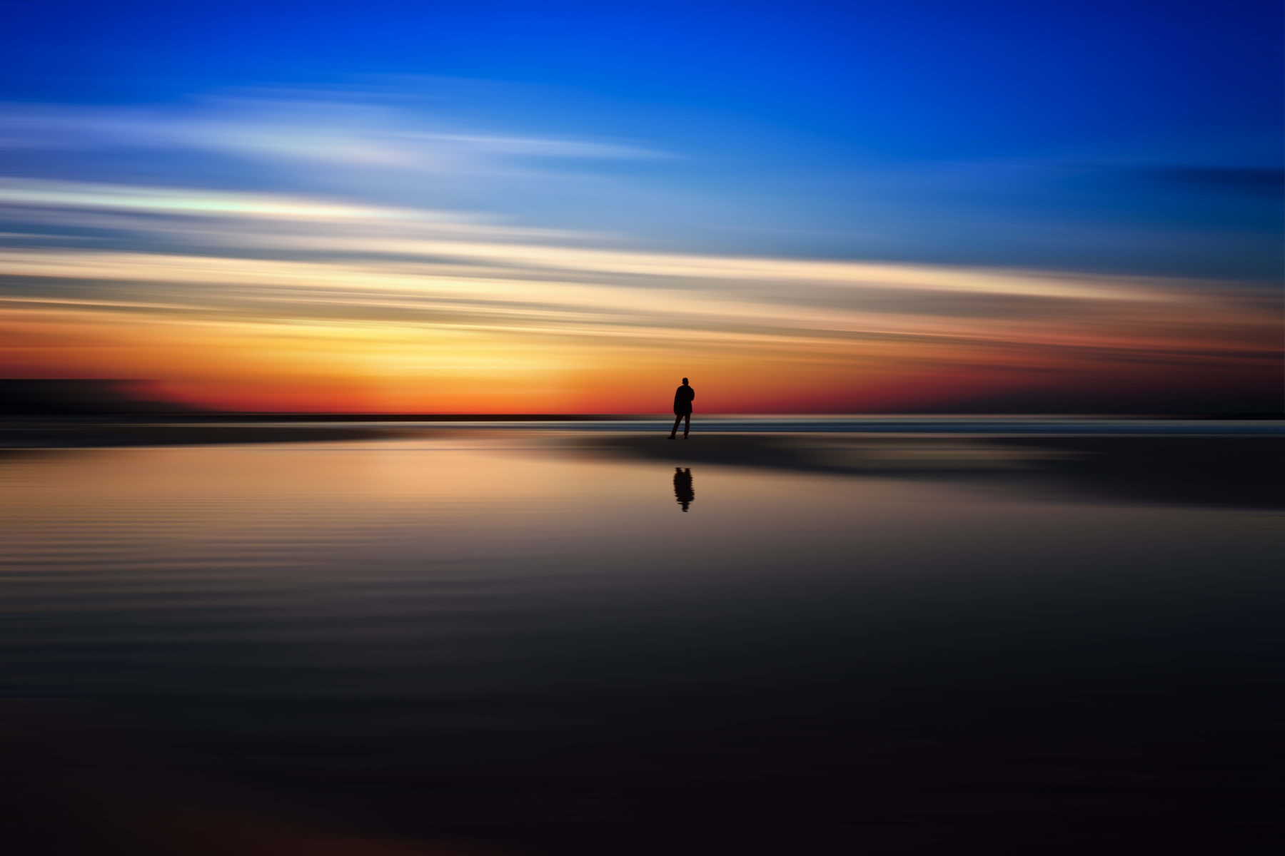 An image of a man with a sunset background